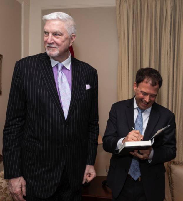 Author Andrew Marble, with former congressman Tom McMillen, learning to sign books standing up.